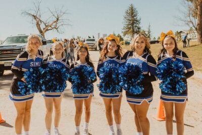 spirit team in uniform with pom poms for homecoming parade