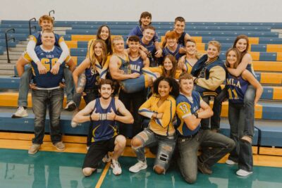 senior class of 2024 poses in the gym for fun photo