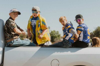 four boys ham it up for the camera from bed of pickup truck at Homecoming