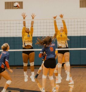 simla volleyball frontline leaps up to block ball bumped over the net